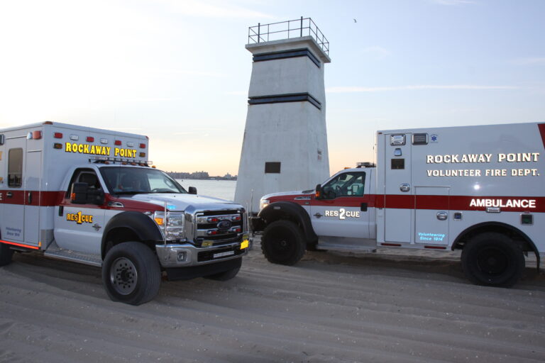 Two ambulance's from Rockaway VFD infront of a light house